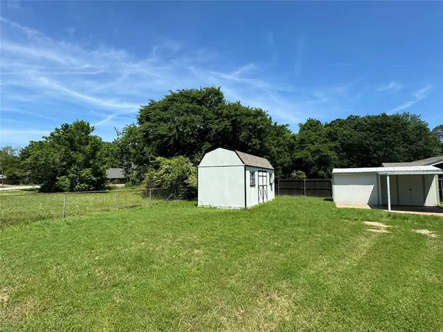 an empty room with a window and a ceiling fan