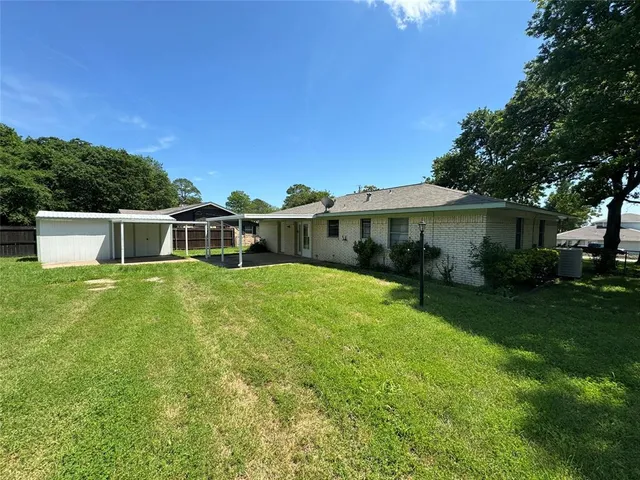 a view of a kitchen with a sink and dishwasher with wooden floor