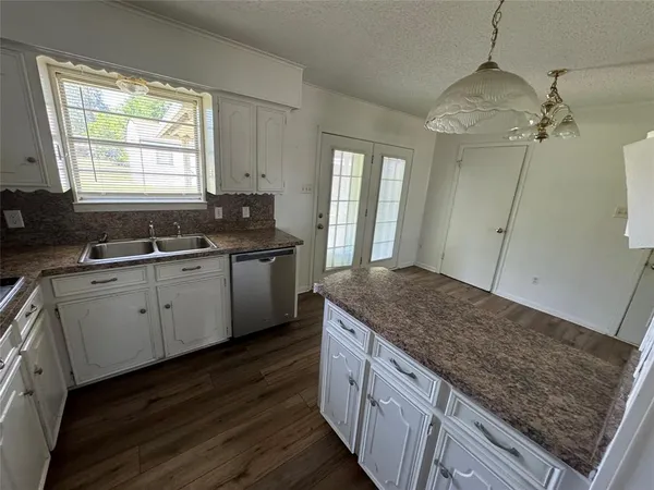 a kitchen with a refrigerator a sink and dishwasher