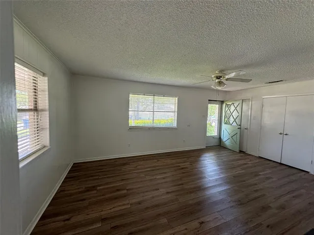 a view of hallway with wooden floor