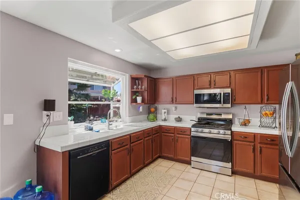 a kitchen with a sink a stove top oven and appliances