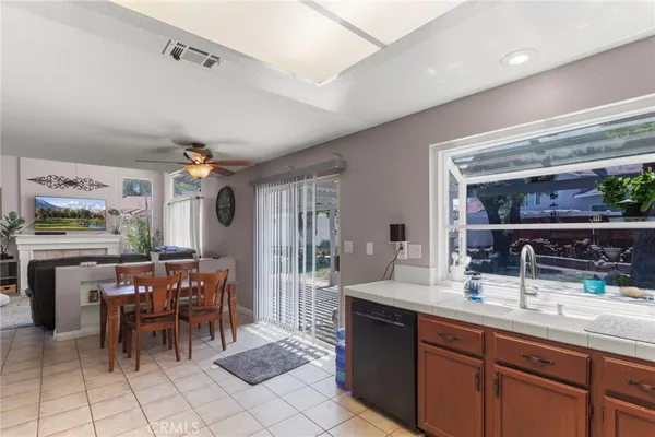 a kitchen with a sink and chairs