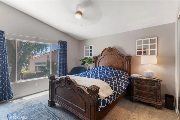 a bedroom with a large bed and a window