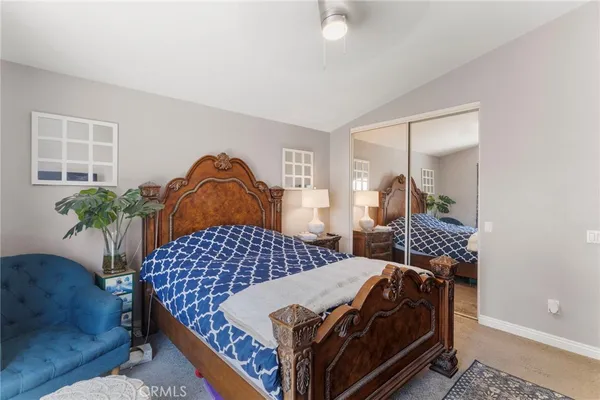 a bedroom with a bed and a potted plant