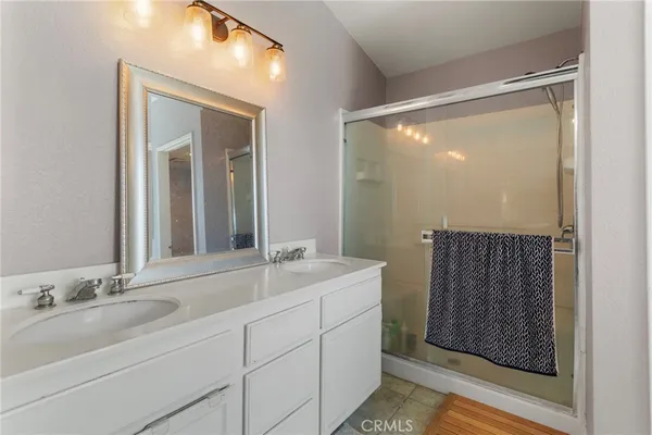 a bathroom with a double vanity sink and mirror