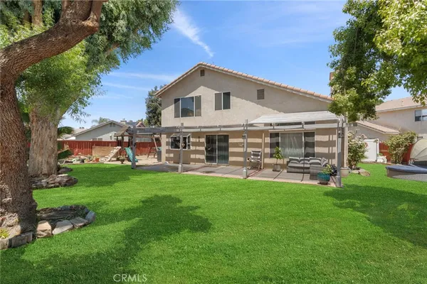 a view of a house with backyard porch and sitting area