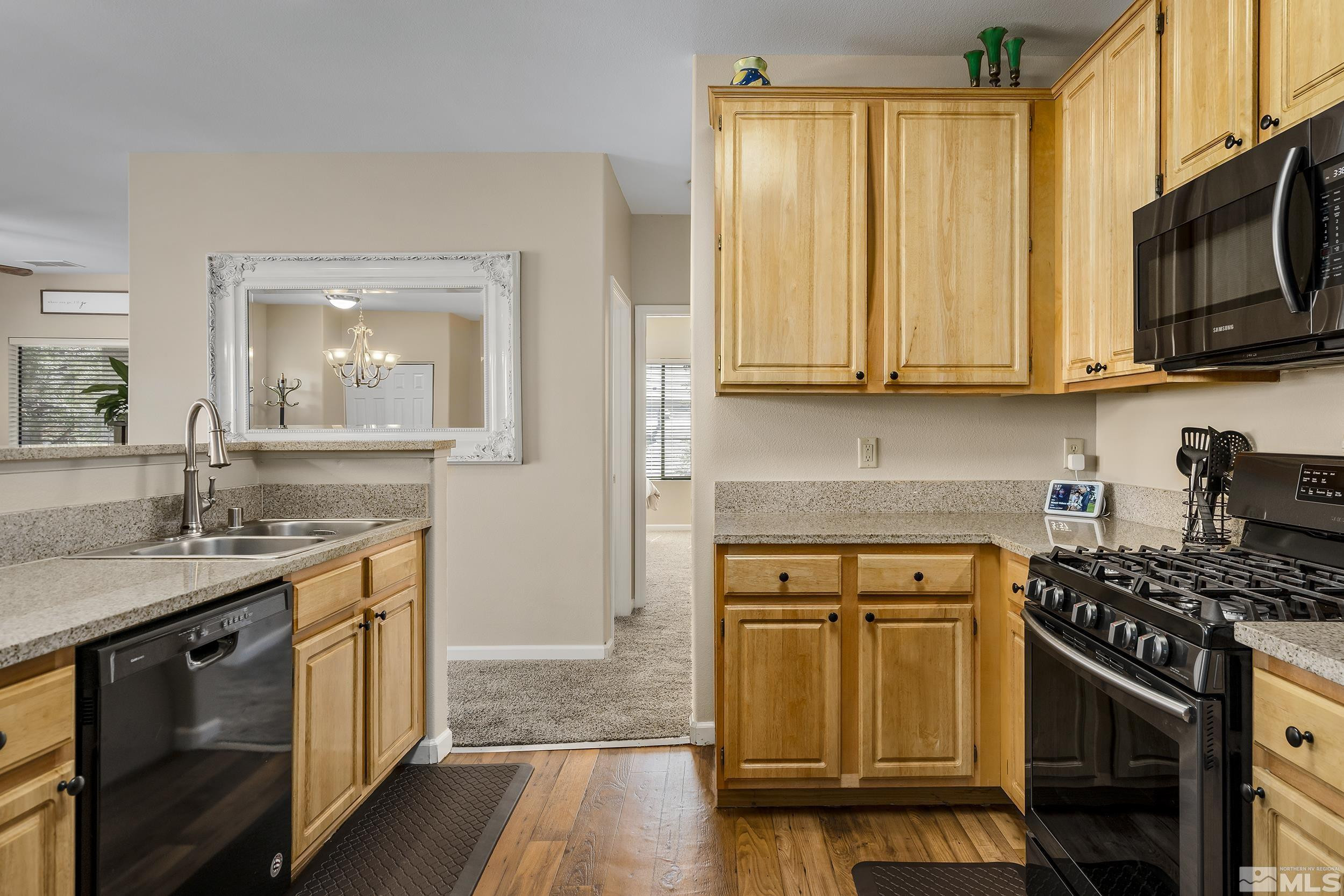 900 South Meadows Parkway, Unit 1621 Reno, NV 89521 - Photo 6 of 23 a kitchen with stainless steel appliances granite countertop a stove a sink and a microwave