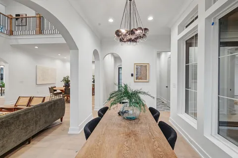 a living room with furniture large window and a fireplace