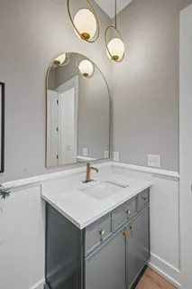 a kitchen with granite countertop white cabinets and stainless steel appliances