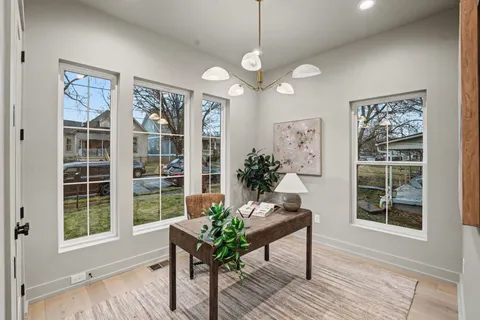 a view of a living room with furniture and wooden floor