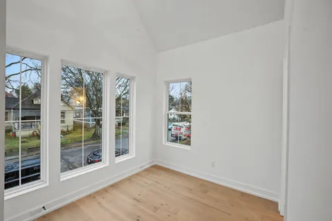 a living room with furniture flowerpot and wooden floor