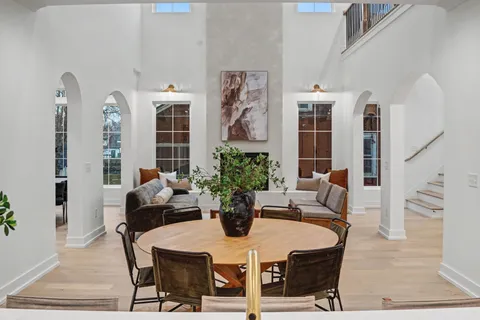 a view of a dining room with furniture and chandelier