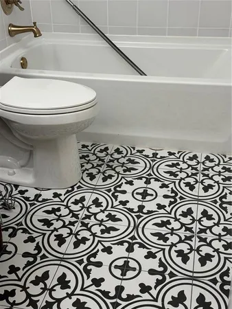 a bathroom with a toilet a sink and a shower