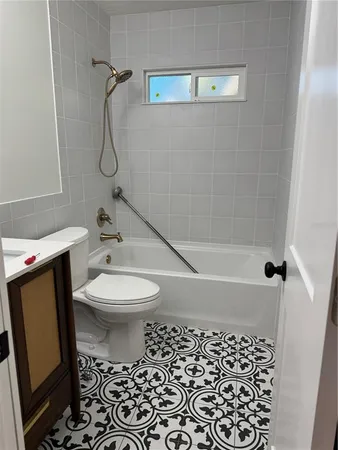 a view of a room with a window and wooden floor