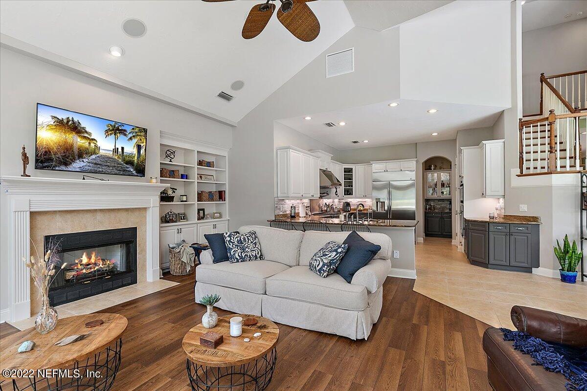 649 Treehouse Circle St. Augustine, FL 32095 - Photo 15 of 71 a living room with furniture and a fireplace