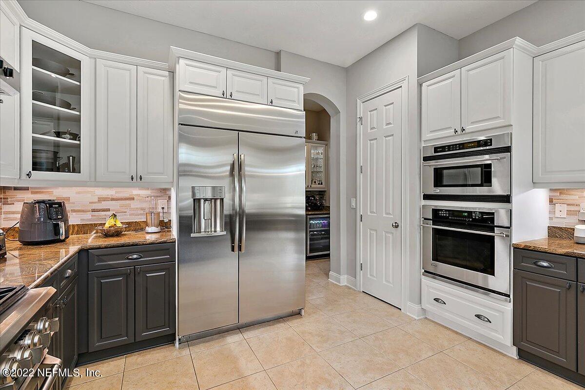 649 Treehouse Circle St. Augustine, FL 32095 - Photo 23 of 71 a kitchen with stainless steel appliances cabinets and a refrigerator