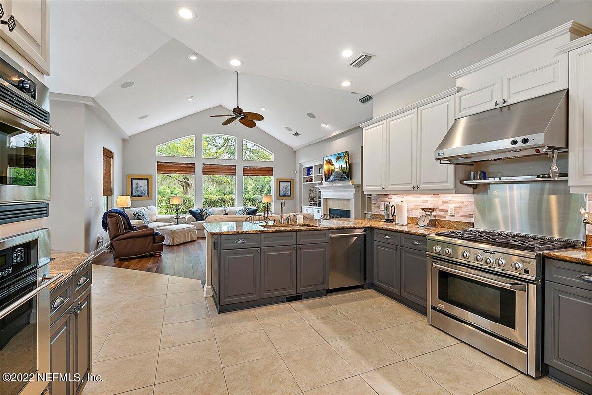649 Treehouse Circle St. Augustine, FL 32095 - Photo 25 of 71 a kitchen with furniture a stove and a refrigerator