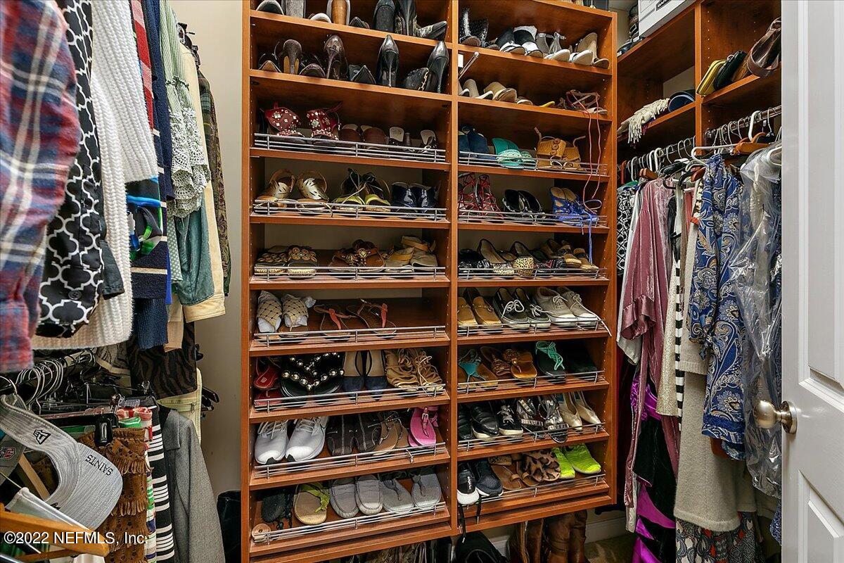 649 Treehouse Circle St. Augustine, FL 32095 - Photo 33 of 71 a view of walk in closet with clothes and shoes