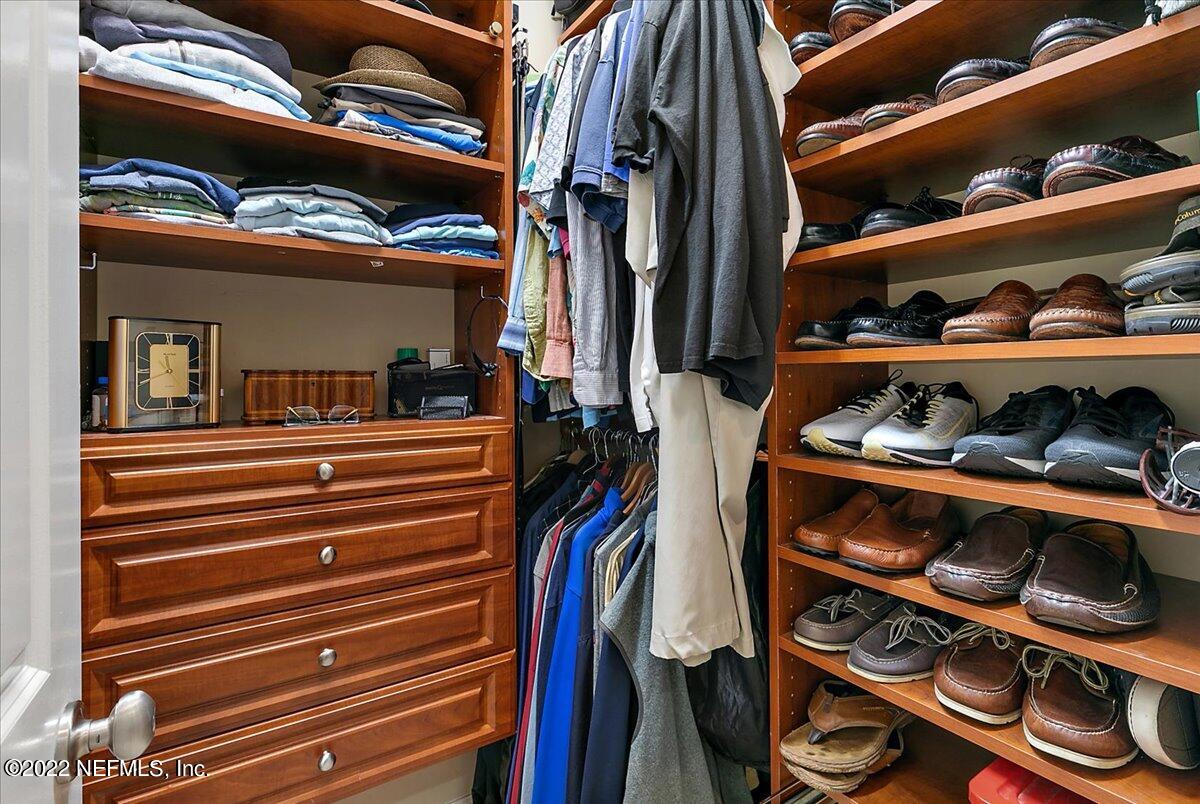 649 Treehouse Circle St. Augustine, FL 32095 - Photo 34 of 71 a view of walk in closet with clothes and shoes