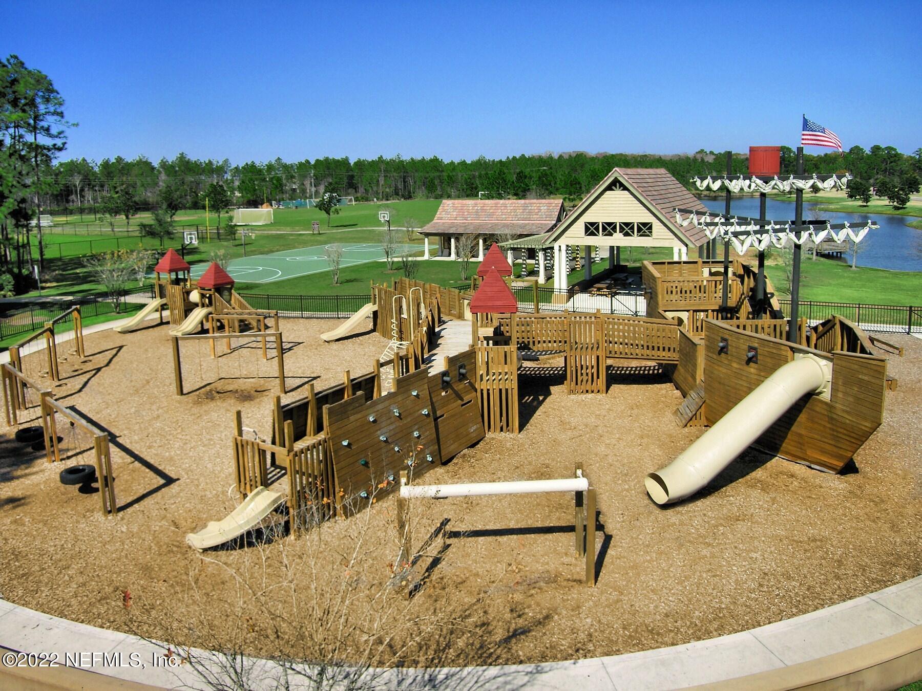 649 Treehouse Circle St. Augustine, FL 32095 - Photo 68 of 71 a view of a swimming pool with a patio and a yard