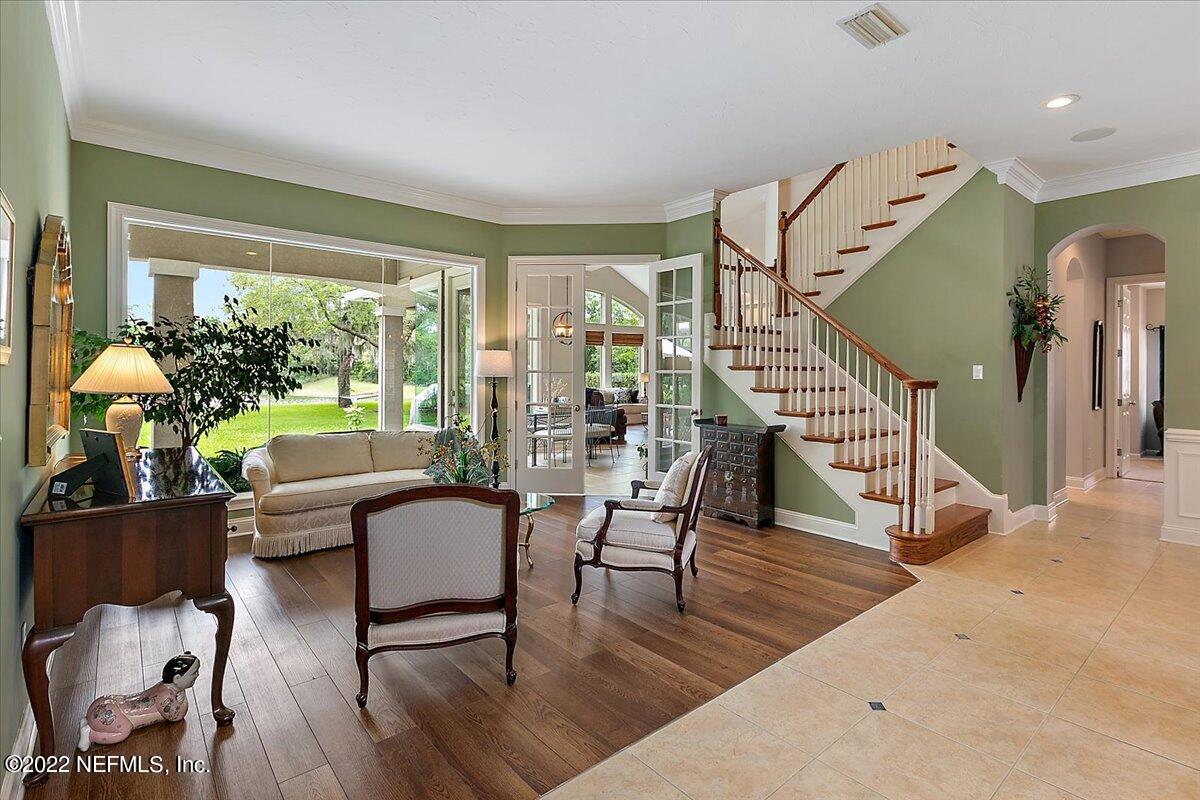 649 Treehouse Circle St. Augustine, FL 32095 - Photo 8 of 71 a living room with furniture and a wooden floor