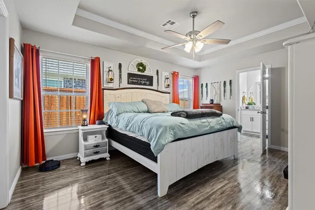 a bedroom with a large bed and a chandelier