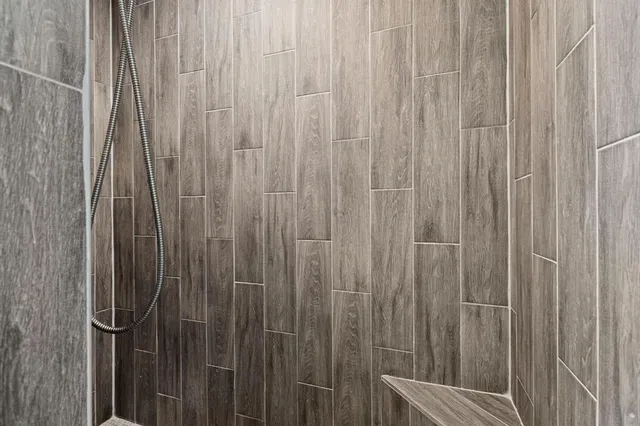 a close view of shower curtain with a wooden curtain