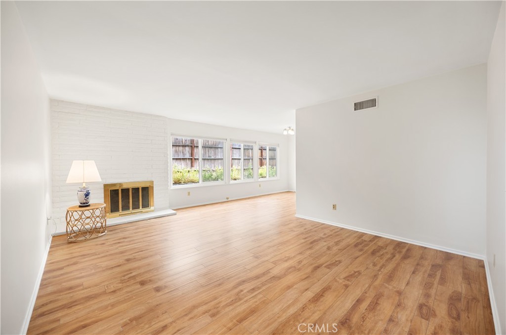 3430 Bahia Place Riverside, CA 92507 - Photo 7 of 34 an empty room with wooden floor and fireplace