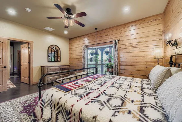 a bedroom with a bed and a chandelier