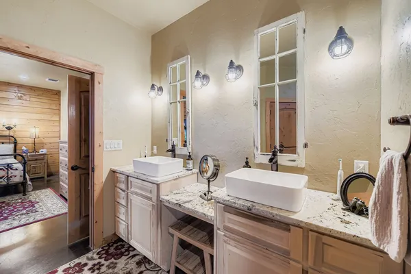 a bedroom with a bed and a chandelier