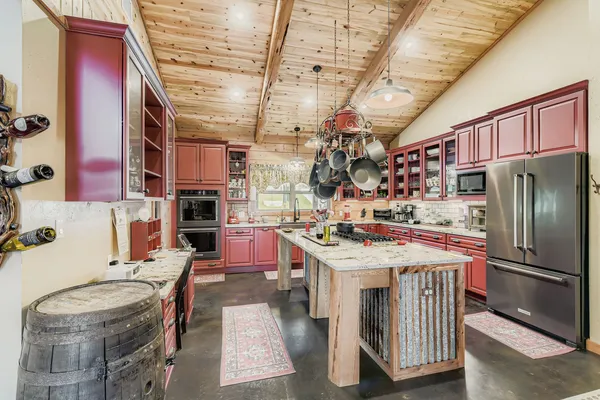 a kitchen that has a lot of cabinets and refrigerator