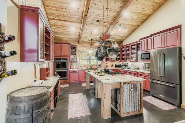 a kitchen that has a lot of cabinets and appliances