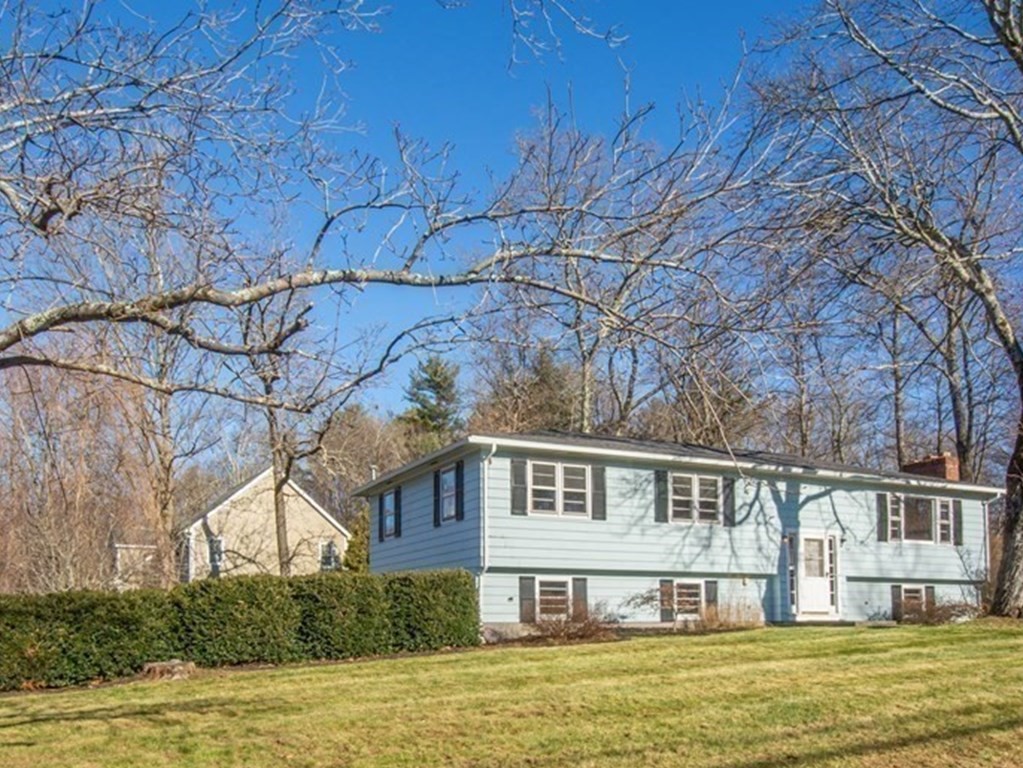 54 Carpenter Road Northbridge, MA 01588 - Photo 1 of 42 a front view of a house with a large window and a tree