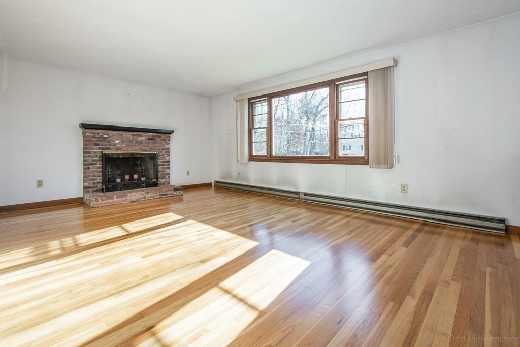 54 Carpenter Road Northbridge, MA 01588 - Photo 11 of 42 a view of an empty room with wooden floor and a window
