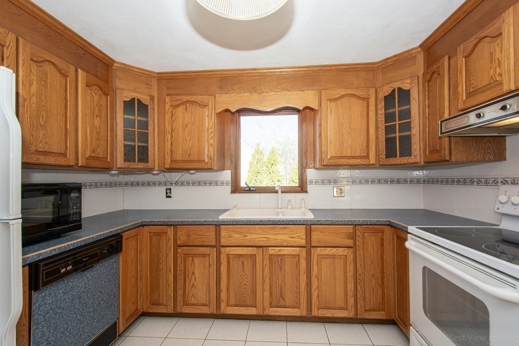 54 Carpenter Road Northbridge, MA 01588 - Photo 16 of 42 a kitchen with stainless steel appliances granite countertop a sink and cabinets