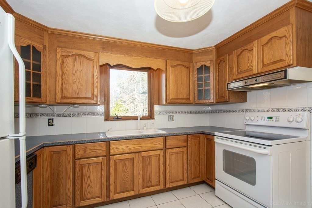 54 Carpenter Road Northbridge, MA 01588 - Photo 17 of 42 a kitchen with stainless steel appliances granite countertop a sink and a stove next to a window