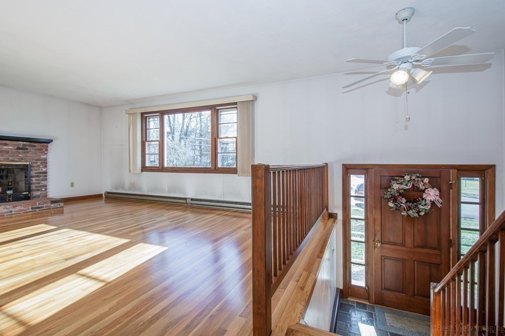 54 Carpenter Road Northbridge, MA 01588 - Photo 8 of 42 a view of an empty room with wooden floor and a window