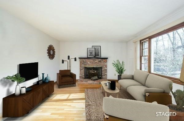 54 Carpenter Road Northbridge, MA 01588 - Photo 10 of 42 a living room with furniture a flat screen tv and a fireplace