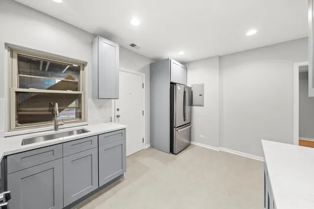 a kitchen with refrigerator and window