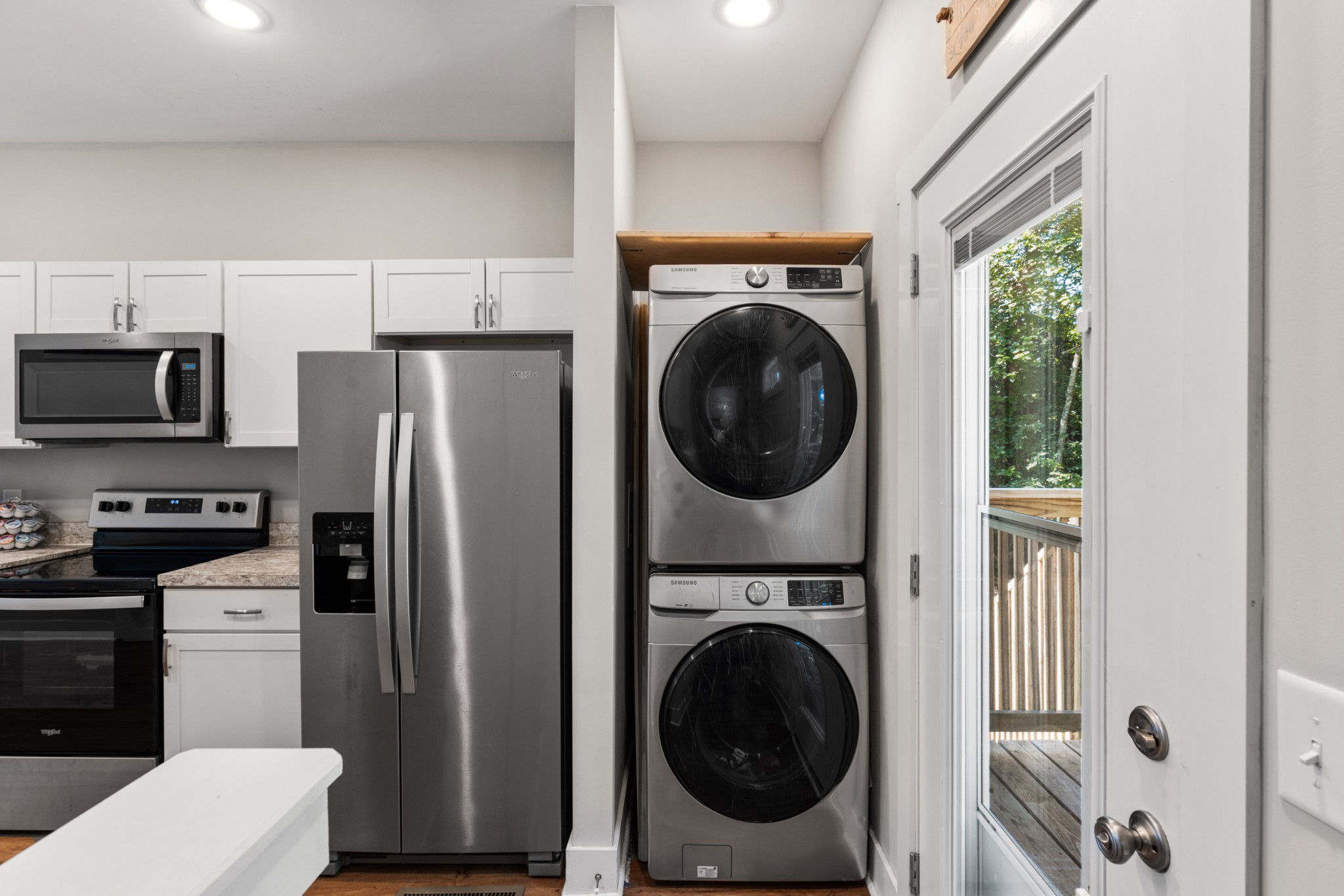 115 North Adams Street Adams, TN 37010 - Photo 21 of 44 a view of a kitchen with stainless steel appliances a refrigerator and a washer dryer