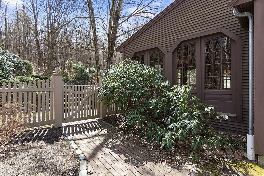 24 Meadow Road Bolton, MA 01740 - Photo 35 of 36 a view of a house with a small yard and plants