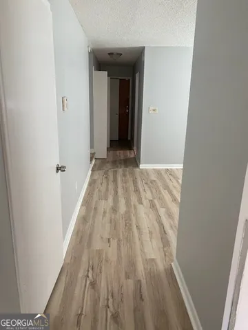 a view of a hallway in wooden floor