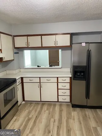 a kitchen with stainless steel appliances cabinets and a counter top