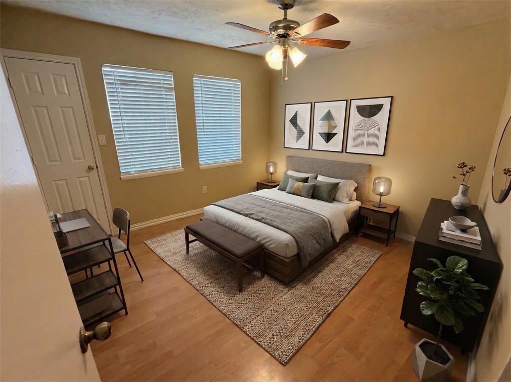 2051 Embassy Way Carrollton, TX 75006 - Photo 16 of 20 a bedroom with a bed and wooden floor