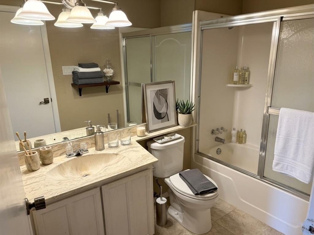 2051 Embassy Way Carrollton, TX 75006 - Photo 18 of 20 a bathroom with a sink toilet and shower