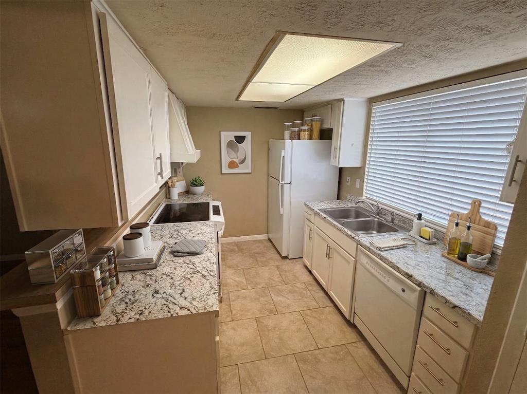 2051 Embassy Way Carrollton, TX 75006 - Photo 6 of 20 a kitchen with a stove and a sink