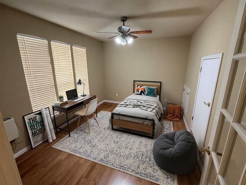 2051 Embassy Way Carrollton, TX 75006 - Photo 8 of 20 a bedroom with a bed and wooden floor
