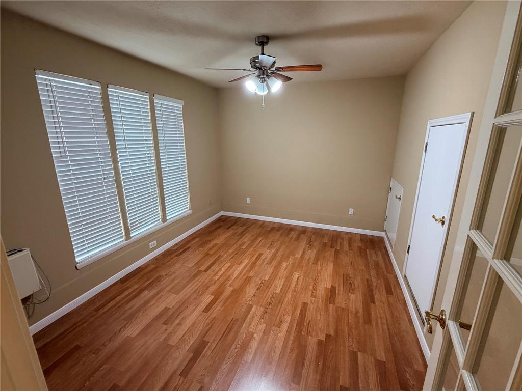 2051 Embassy Way Carrollton, TX 75006 - Photo 9 of 20 a view of an empty room with wooden floor and a window