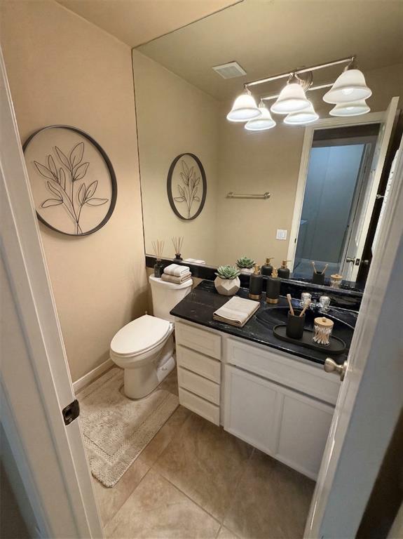 2051 Embassy Way Carrollton, TX 75006 - Photo 10 of 20 a bathroom with a toilet sink and mirror