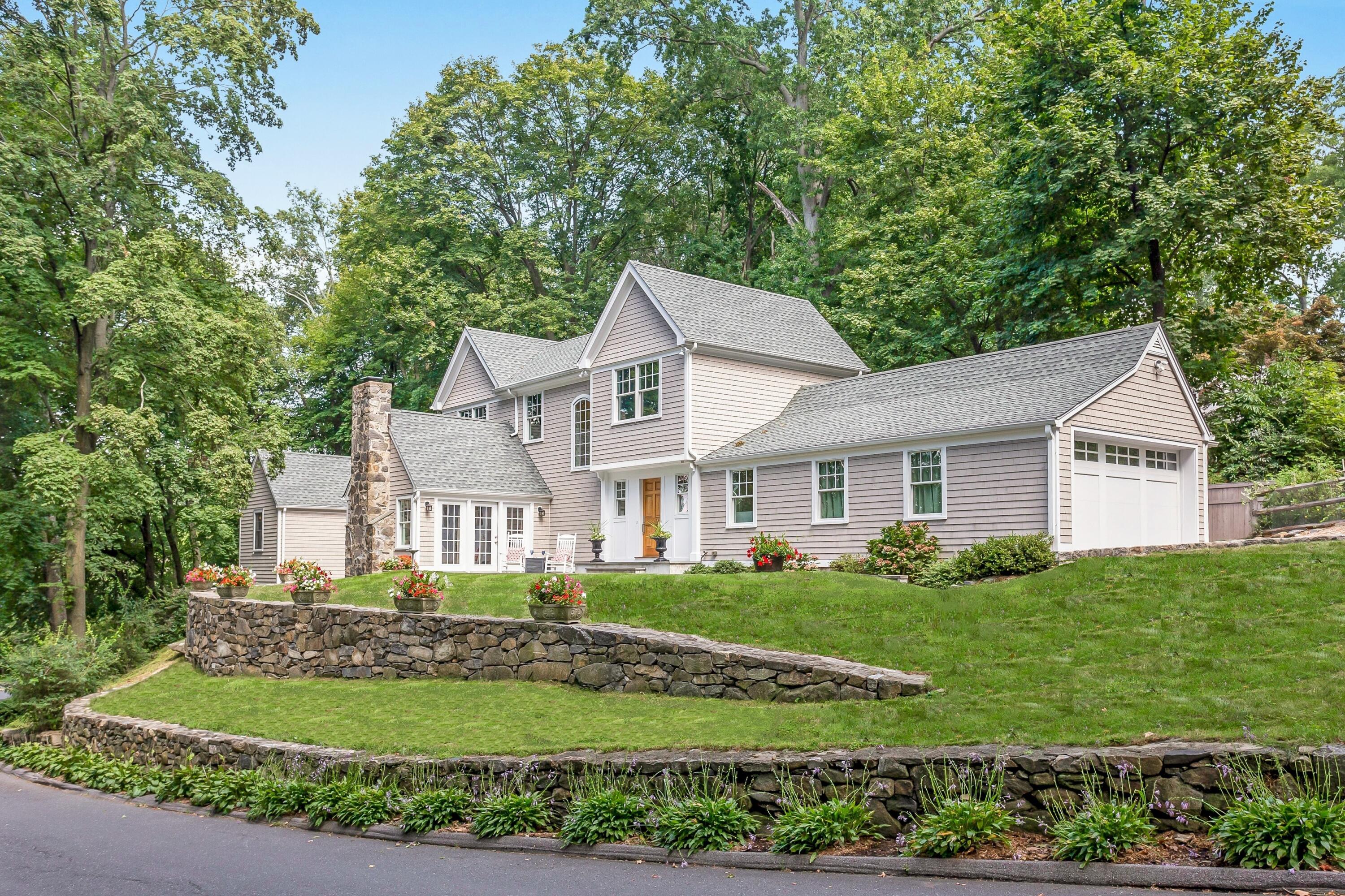 a front view of a house with a garden